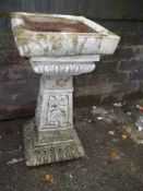 A CONCRETE BIRD BATH