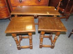 A SOLID OAK NEST OF THREE TABLES
