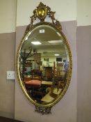 A DECORATIVE GILT OVAL WALL MIRROR H-88 CM