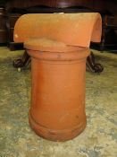 A TERRACOTTA CHIMNEY POT WITH COWELL