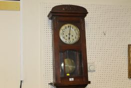 A VINTAGE OAK CASED GONG STRIKE WALL CLOCK