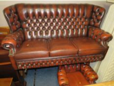 AN OXBLOOD RED LEATHER THREE SEATER SETTEE AND ARMCHAIR (2)