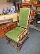 A VINTAGE AMERICAN ROCKING CHAIR WITH UPHOLSTERED DETAIL