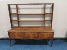 A GEORGIAN OAK DRESSER, with later open rack, three drawers to the base, with crossbanded detail,