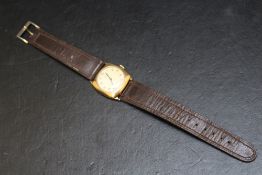 A RECORD 9CT GOLD WRIST WATCH, on leather strap, with presentation engraving to reverse, Dia 3
