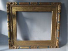 AN EARLY 20TH CENTURY GOLD AND BLUE DECORATIVE FRAME, with slip, frame W 7 cm, rebate 63 x 72 cm