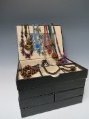 A STACKING JEWELLERY BOX AND CONTENTS, comprising of approximately 40 handcrafted bead necklaces,
