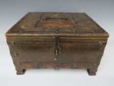 A 19TH CENTURY TABLE TOP WOODEN BOX, with carved decorations and metal bindings, H 19 cm, W 34 cm, D