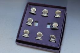 A BOXED SET OF EIGHT CLAM SHELL MENU HOLDERS, box W 16 cm