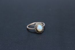 A VINTAGE OPAL AND DIAMOND RING, in a traditional setting, ring size M 1/2