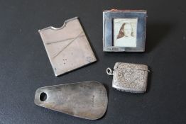A HALLMARKED SILVER MINIATURE PHOTO FRAME, together with a small hallmarked silver vesta, a small