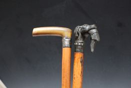 TWO MALACCA WALKING STICKS, one having a dog's head holding a pheasant in its mouth, L 77 cm