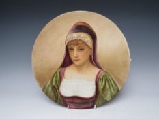 A PINDER BOURNE & Co CHARGER DEPICTING A LADY IN A HOODED ROBE, with impressed marks to the