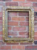A 19TH CENTURY DECORATIVE GOLD FRAME, decoration is moulded card laid on to a wooden base, frame W 9