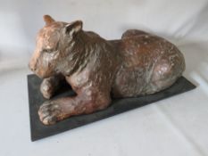 A VINTAGE COMPOSITE SCULPTURE OF A BENGAL TIGER, raised on a wooden base, inscribed, H 30 cm, L 59 c