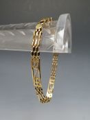 A 9CT GOLD THREE BAR ART NOUVEAU STYLE GATE BRACELET, the three bar links interspersed with Rennie