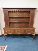 A GEORGE III OAK DRESSER WITH FULL PLATE RACK, the rack with two cupboards, the three drawer base