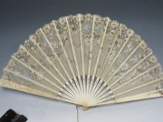 TWO ANTIQUE FANS, comprisong an ebonised example with sequin embellishment, L 33 cm, open W 62 cm