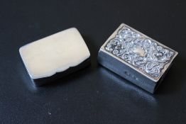 A HALLMARKED SILVER PILL BOX - BIRMINGHAM 1924, together with a hallmarked silver matchbox cover,