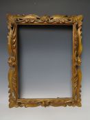 A 19TH CENTURY DECORATIVE CARVED WOODEN PIERCED GOLD FRAME, frame W 5 cm, rebate 30 x 40 cm