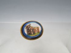 A LATE 19TH / EARLY 20TH CENTURY GRAND TOUR STYLE MICRO MOSAIC BROOCH, the oval blue polished