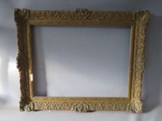 A LATE 19TH / EARLY 20TH CENTURY DECORATIVE SWEPT GOLD FRAME, frame W 9 cm, rebate 62 x 47 cm