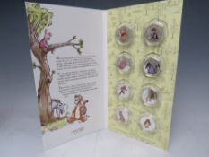 A WINNIE THE POOH LIMITED EDITION SILVER 50 PENCE SHAPED DECORATIVE COIN SET, number 171 of 499,