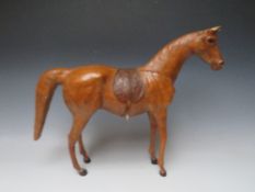 A LARGE VINTAGE LEATHER MODEL OF A HORSE, with saddle and tack, H 39 cm