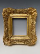 A SMALL 19TH CENTURY GILT DECORATIVE SWEPT FRAME, frame W 6.5 cm, rebate 16 x 14 cm