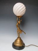 AN ART DECO FIGURAL SPELTER TABLE LAMP IN THE FORM OF A DANCING LADY, with gilt finish, circular
