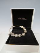 A PANDORA CHARM BRACELET WITH ATTACHED CHARMS, together with a collection of empty Pandora boxes (