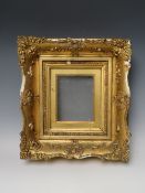 A 19TH CENTURY GOLD SWEPT FRAME, with gold slip and glazed, in need of some restoration, frame W 8