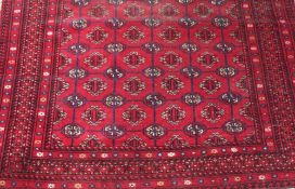 A LATE 19/EARLY 20TH CENTURY EASTERN WOOLLEN RUG - MAINLY RED GROUND 173 X 130 CM