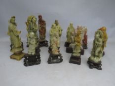 A COLLECTION OF TALLER ORIENTAL CARVED SOAPSTONE FIGURES / DEITIES, each figure mounted on a