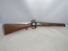 A 19TH CENTURY SHORT BARRELED PERCUSSION MUSKET, with metal ramrod, indistinct inscriptions on
