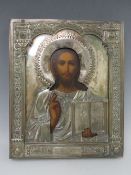 A 19TH CENTURY RUSSIAN ICON WITH WHITE METAL OKLAD, inscribed verso 'To The Spiritual Leader of