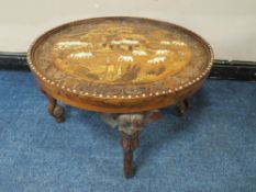 A 20TH CENTURY HARWOOD AND INLAID 'ELEPHANT' CIRCULAR OCCASIONAL TABLE, the top having extensive