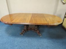 A LARGE 19TH CENTURY MAHOGANY PULL-OUT EXTENDING DINING TABLE, having two additional leaves,