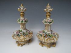 A PAIR OF CONTINENTAL FLORAL ENCRUSTED PORCELAIN SCENT BOTTLES / VASES AND COVERS, H 24 cm, S/D