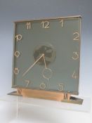 AN ART DECO 8 DAY GLASS MANTLE CLOCK, of square form on a shaped base, H 20.5 cm, W 20 cm