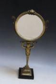 A GILT METAL FIGURAL ADJUSTABLE TABLE MIRROR, H 44 cm