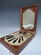 A VINTAGE LEATHER CASED VANITY / DRESSING TABLE MANICURE SET, the hinged lid having attached pull