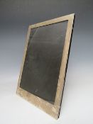 A LARGE LONDON HALLMARKED SILVER EASEL BACK PHOTO FRAME, overall H 35.5, W 25 cm, rebate approx.
