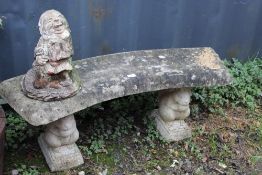 A CURVED CONCRETE GARDEN BENCH WITH A GNOME (2)