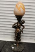 A MODERN COLOUR GLASS SHADE FIGURATIVE LAMP