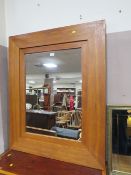 A LARGE MODERN WOODED FRAMED MIRROR 110 X 90 CM