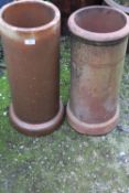 TWO CIRCULAR TERRACOTTA CHIMNEY POTS