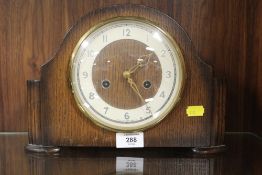 A VINTAGE OAK CASED MANTEL CLOCK