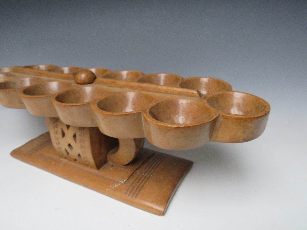 AN AFRICAN TRIBAL ASHANTI 'MANCALA' BEAD GAME BOARD, on a raised stand with pierced decoration, W 68 - Image 3 of 6
