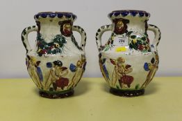A PAIR OF CONTINENTAL STYLE TWIN HANDLED VASES
